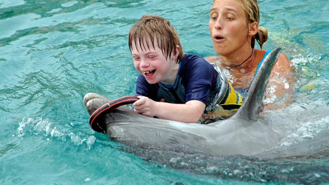 Der Junge, der sterben sollte: Tim als Zehnjähriger bei einer Delfin-Therapie. Das Spiel mit den Tieren tut dem schwerstbehinderten Jugend sichtlich gut.