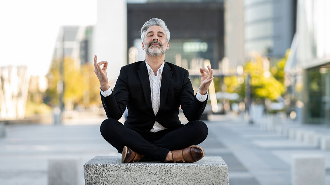 Ein Mann meditiert in der Stadt Symbolfoto: Imago
