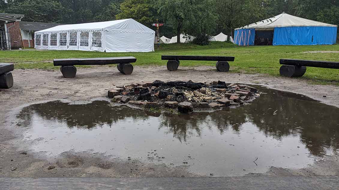 Eine große Pfütze hat sich auf dem Lagerfeuer-Platz auf dem Zeltplatz des BDKJ-Jugendhofs in Vechta gebildet. Rechts zu sehen ist das fest installierte Aktionszelt auf dem Jugendhof.