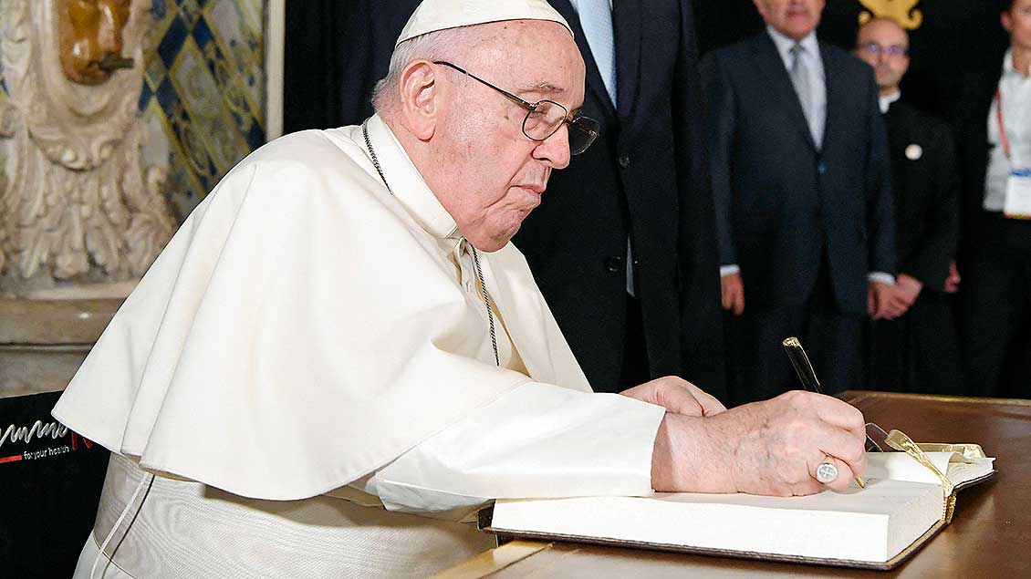 Papst Franziskus schreibt in ein Goldenes Buch