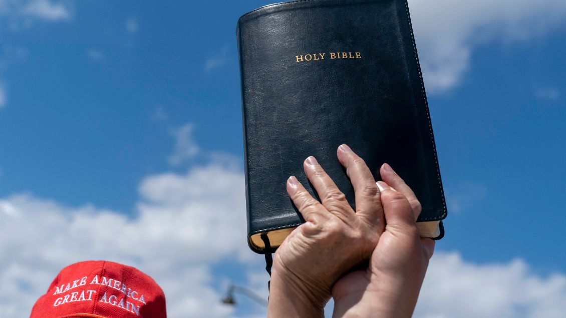 Hand eines Trump-Anhängers mit Bibel